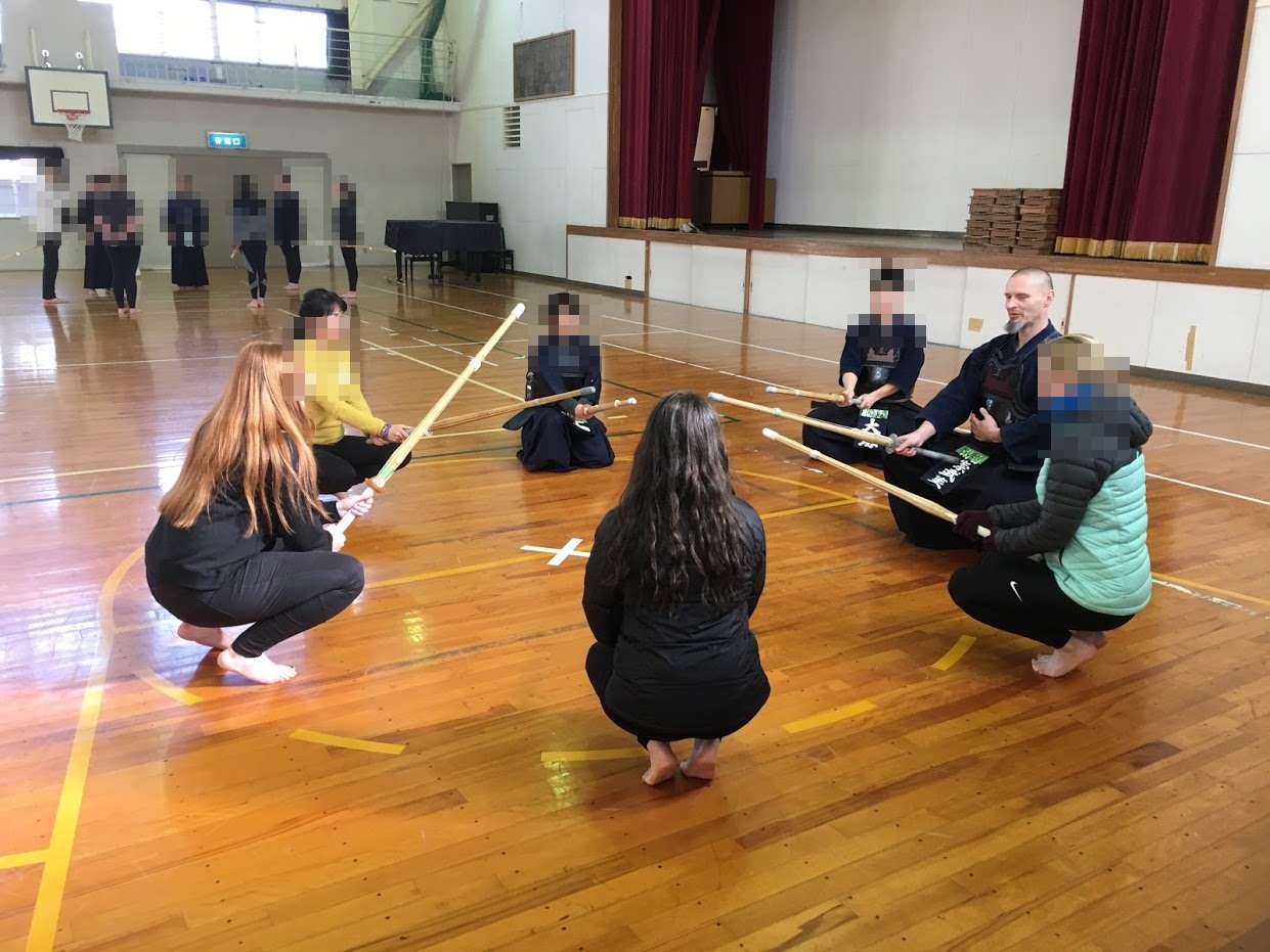 International visitors trying kendo in a circle with Kosei Kendo Club members